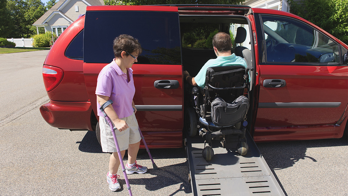 photo of couple with Cerebral Palsy getting into an adaptive vehicle